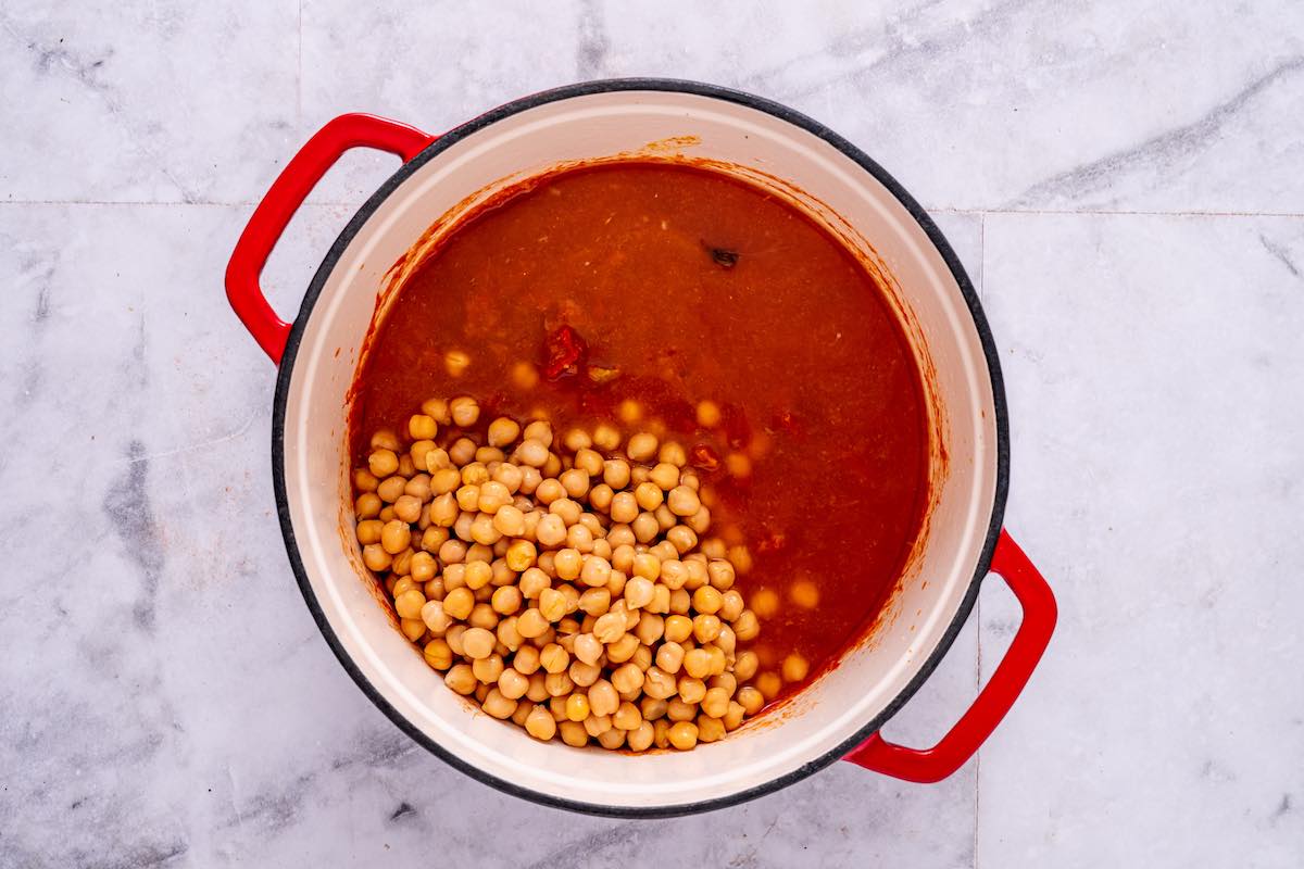 adding chickpeas to tomato spice mix.