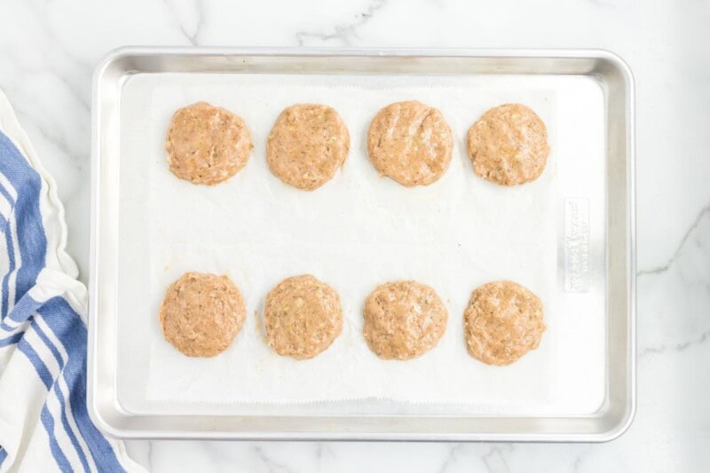 shaped raw chicken patties.