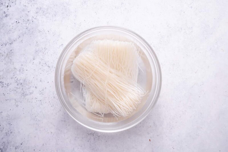 rice noodles soaking in a bowl.