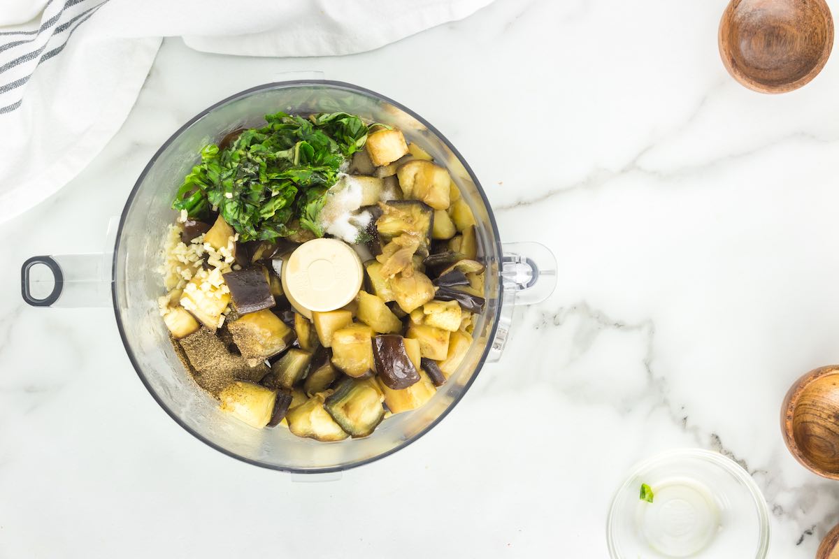 cooked eggplant, garlic, onion, and spinach in a blender.