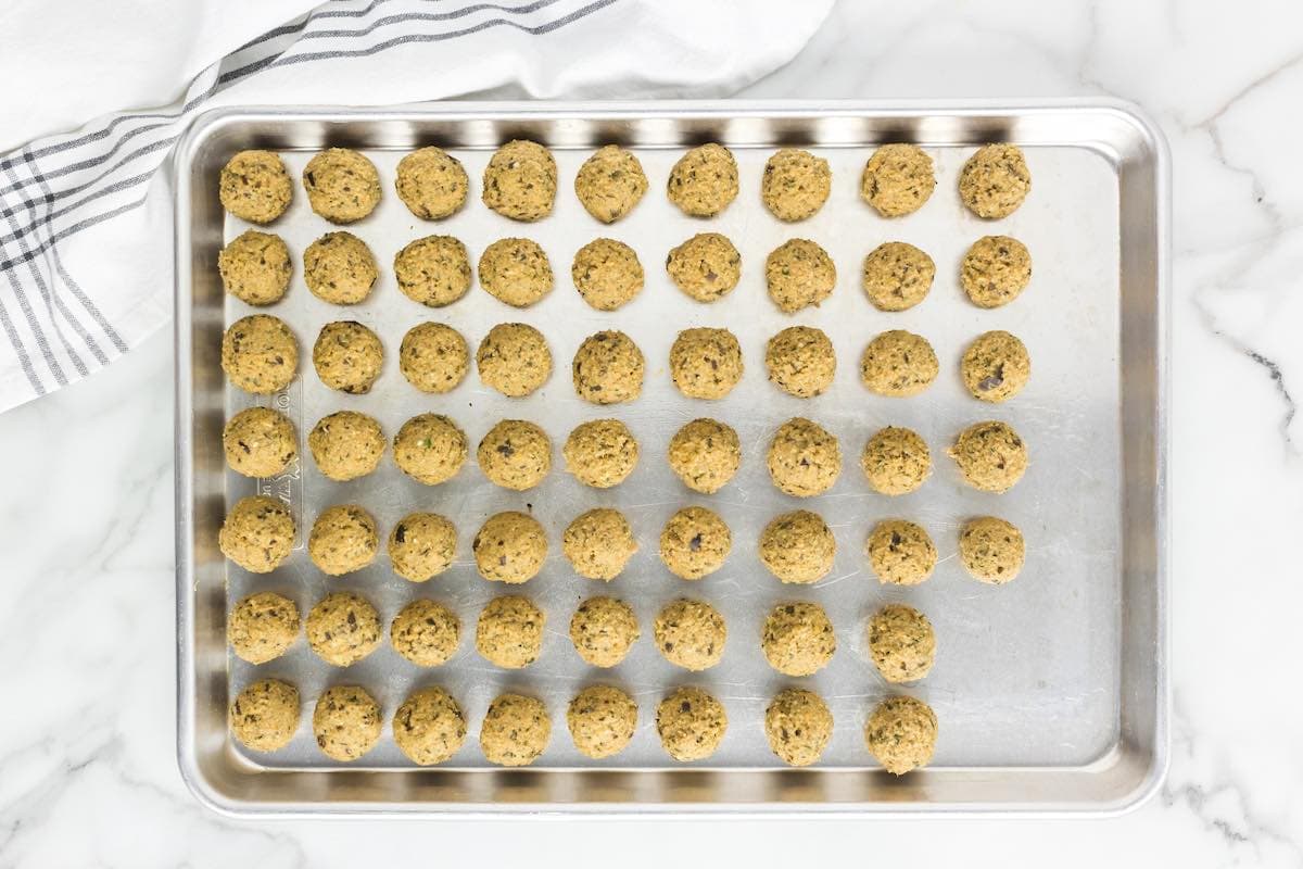 shaped eggplant meatballs on a baking sheet.