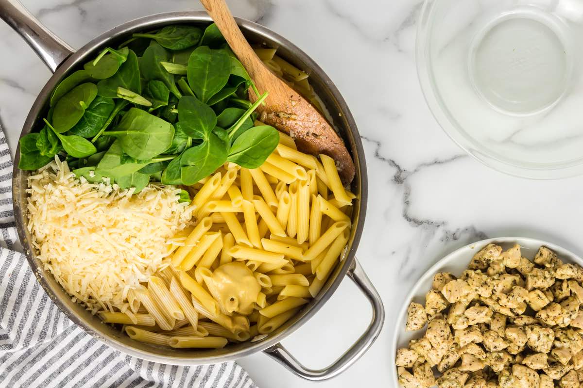 pasta combined with spinach and shredded cheese.