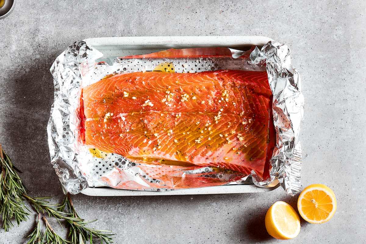 seasoned salmon fillet in a baking dish.