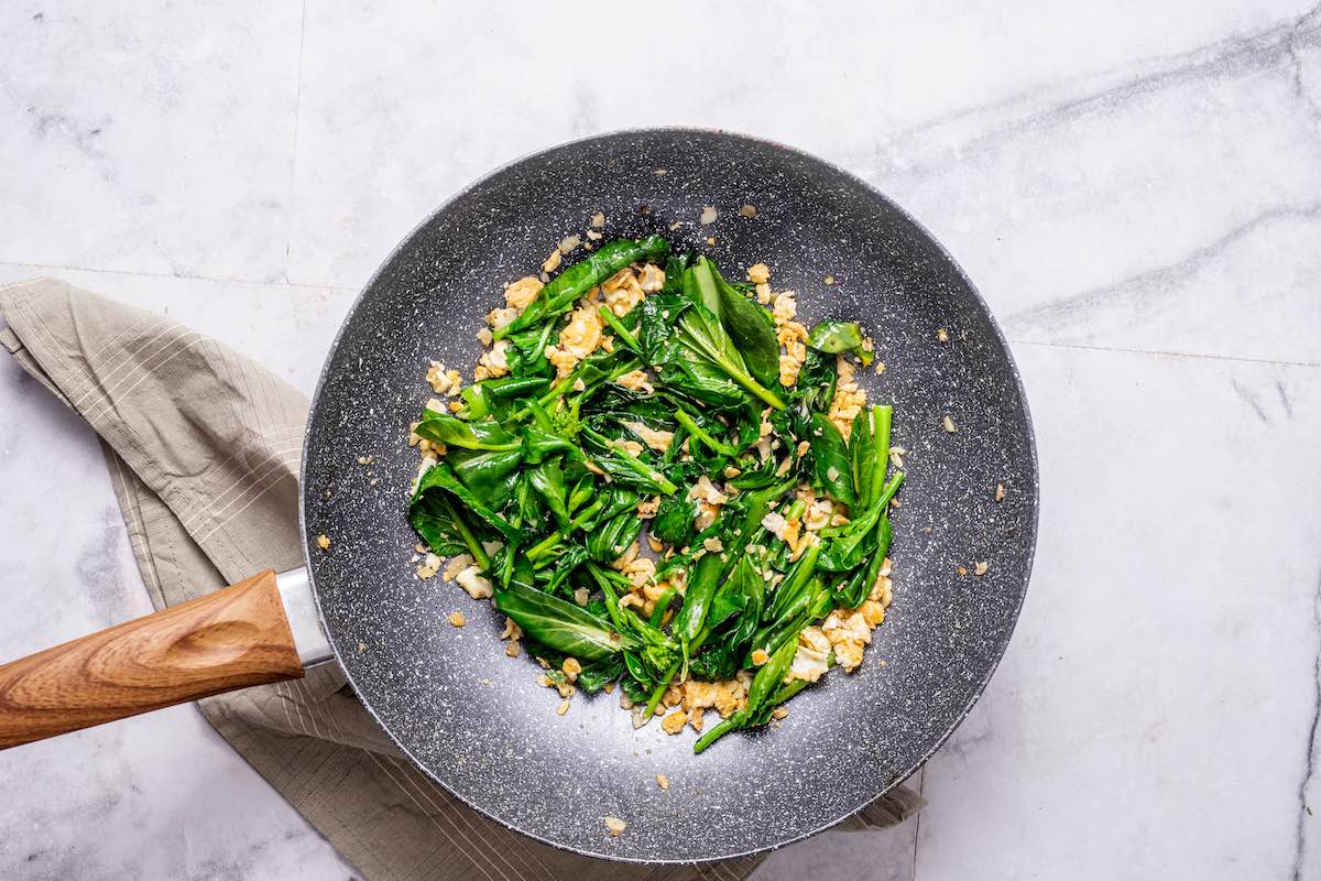 Chinese broccoli and scrambled egg in a pan.