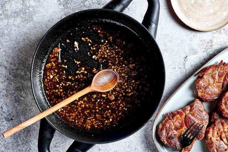 glaze thickening in a skillet with pork juices.