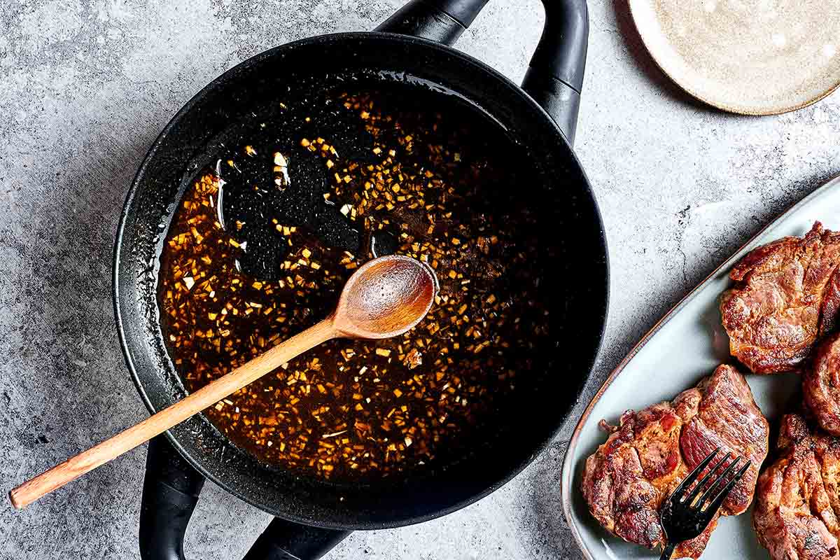 glaze thickening in a skillet with meat juices.