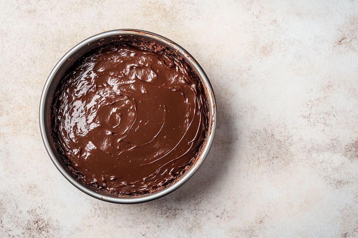 cake batter in a round cake tin.