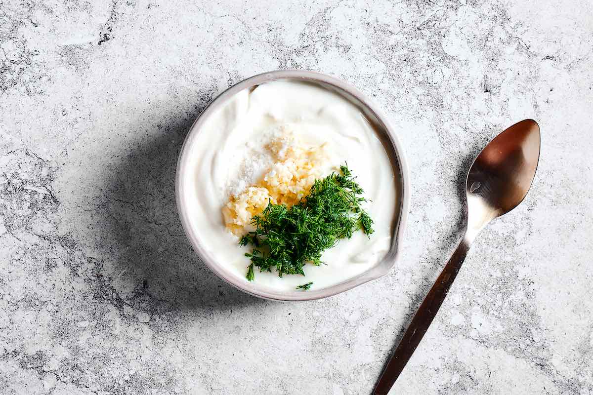 yogurt, garlic, and herbs in a bowl.