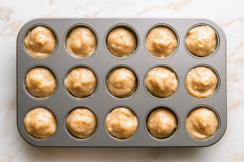 12-count muffin tin with batter in it.