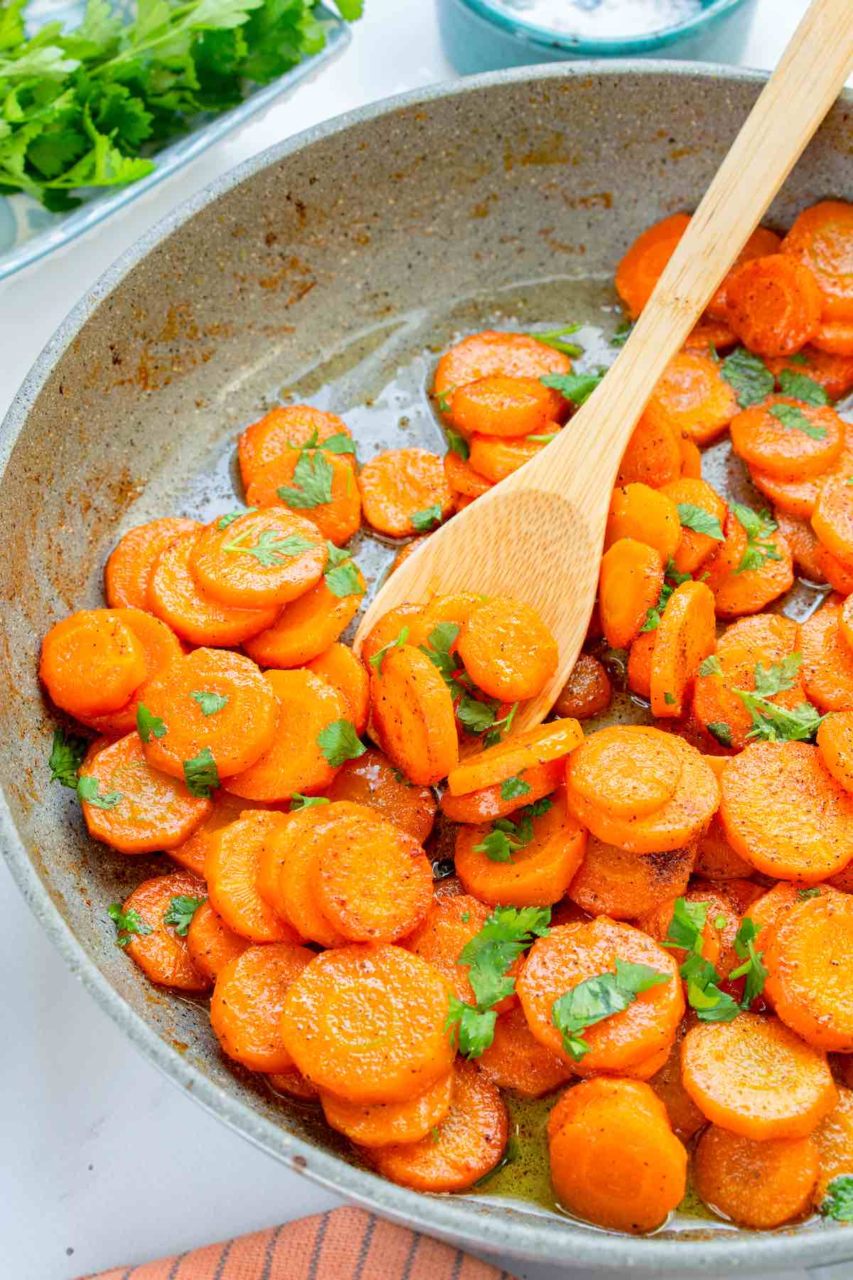 sauteed carrots with fresh herbs on top.