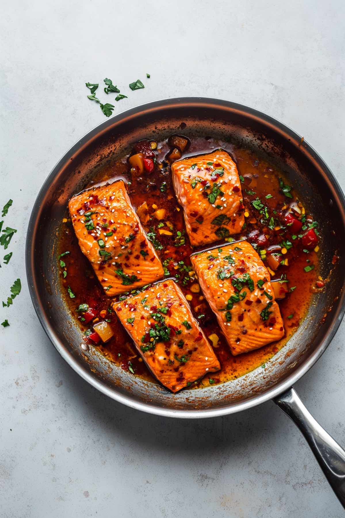 sweet chili salmon in a skillet.