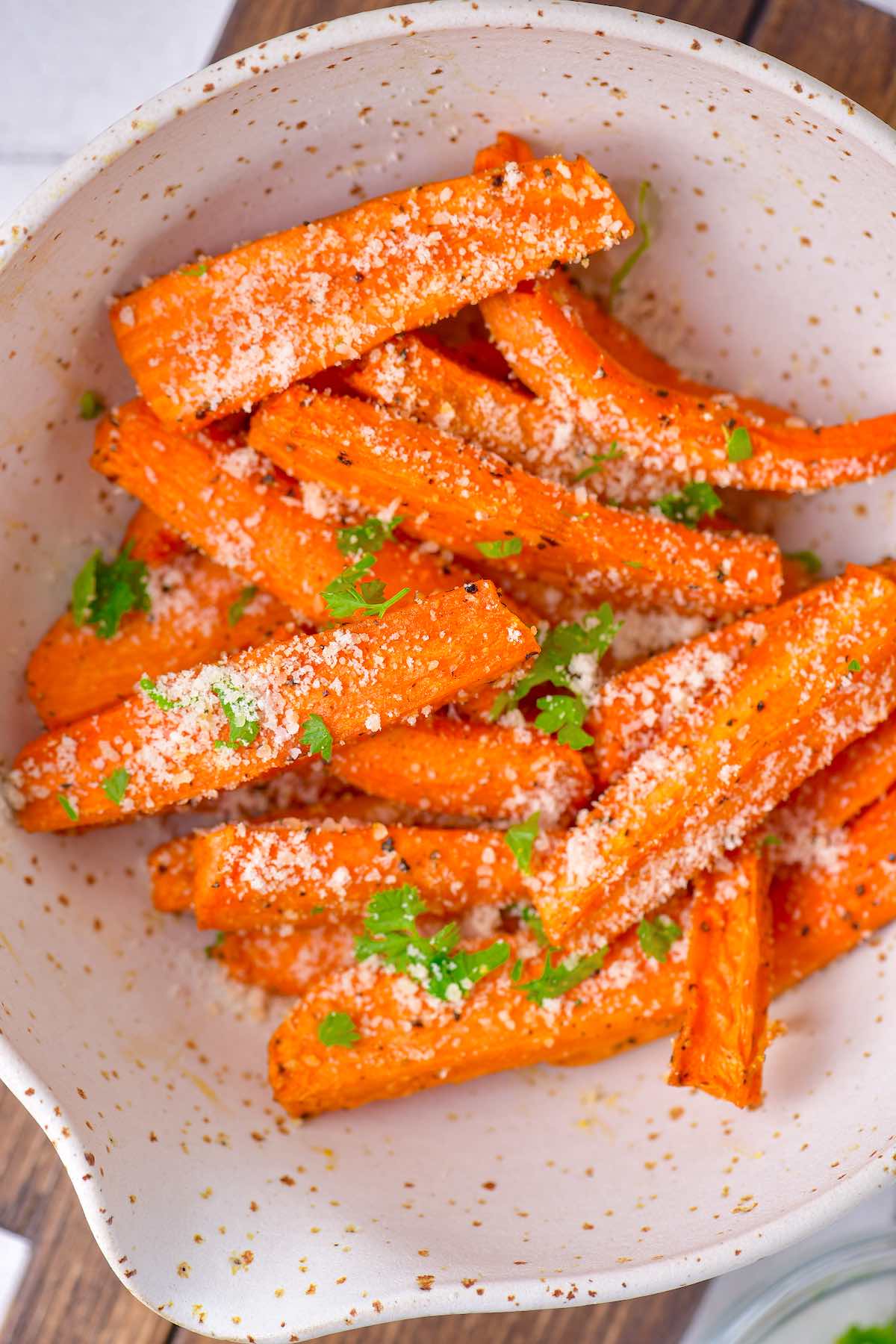 air fryer carrots with parmesan cheese and fresh herbs.