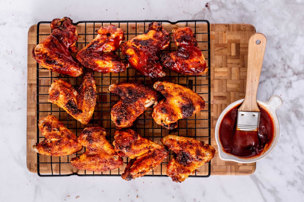 basting BBQ sauce on the wings.