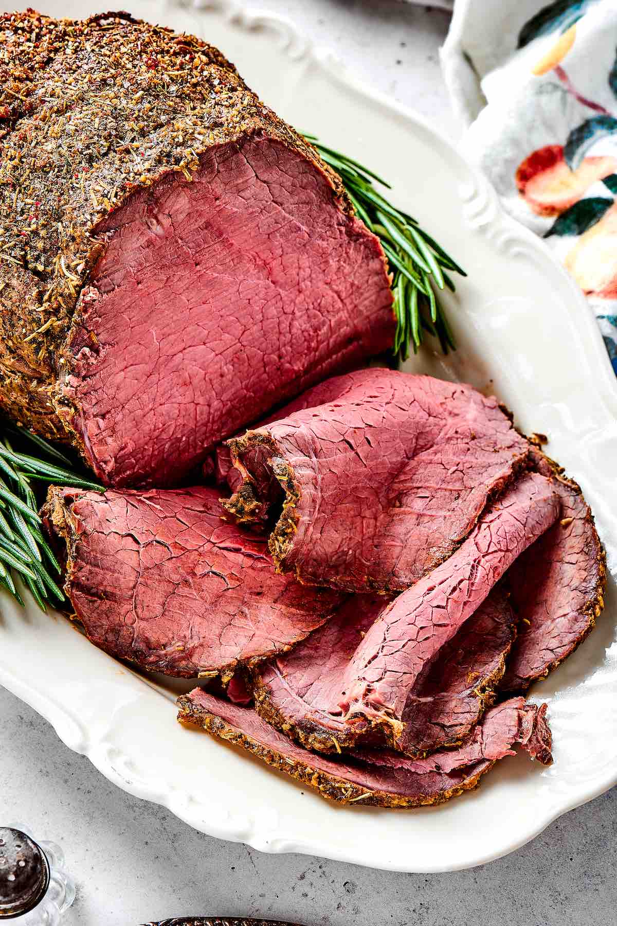 eye of round roast on a plate, sliced.