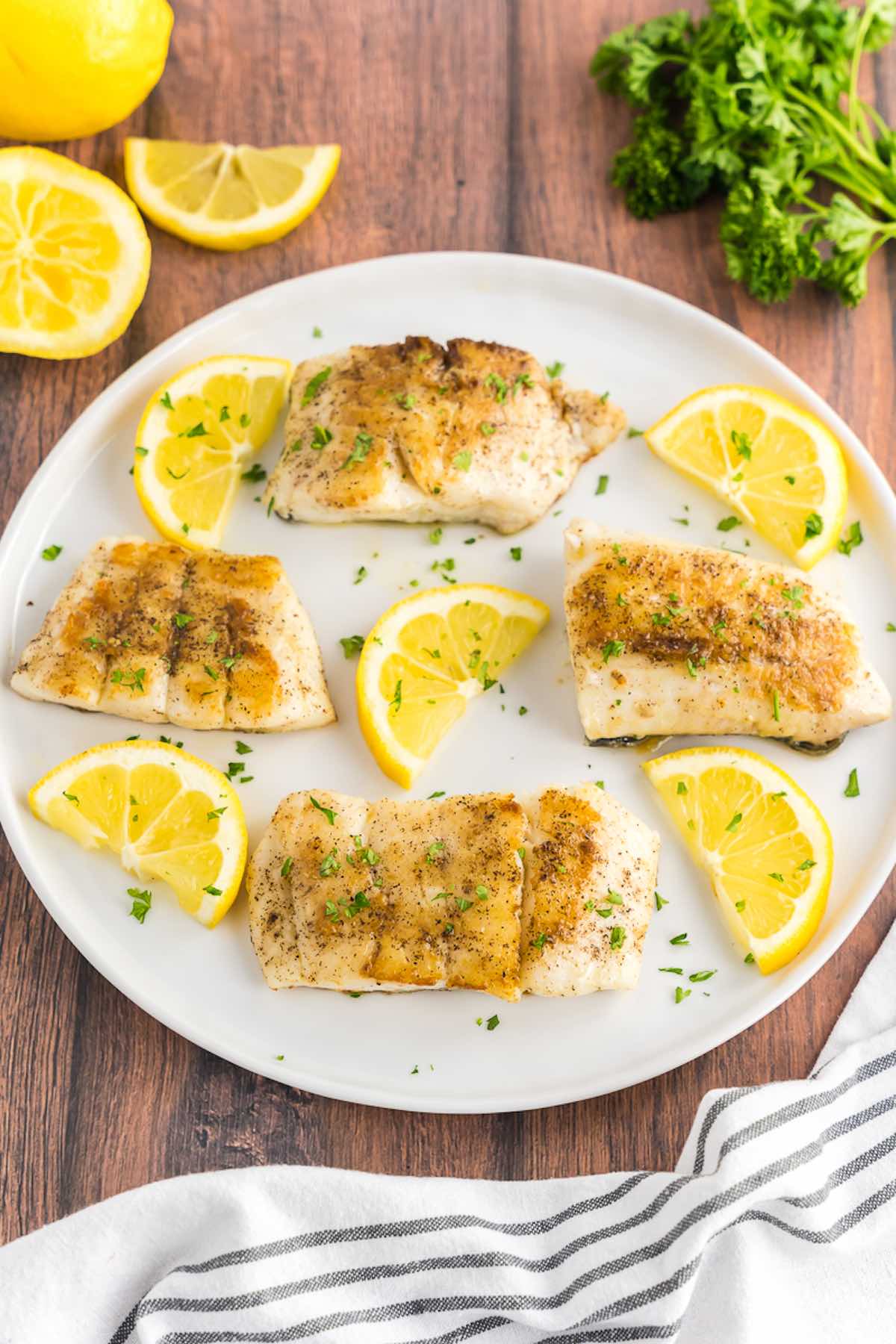 homemade grilled haddock with lemon slices.