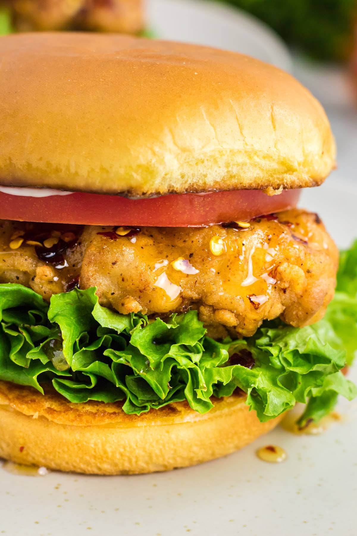 honey hot chicken sandwich on a plate.