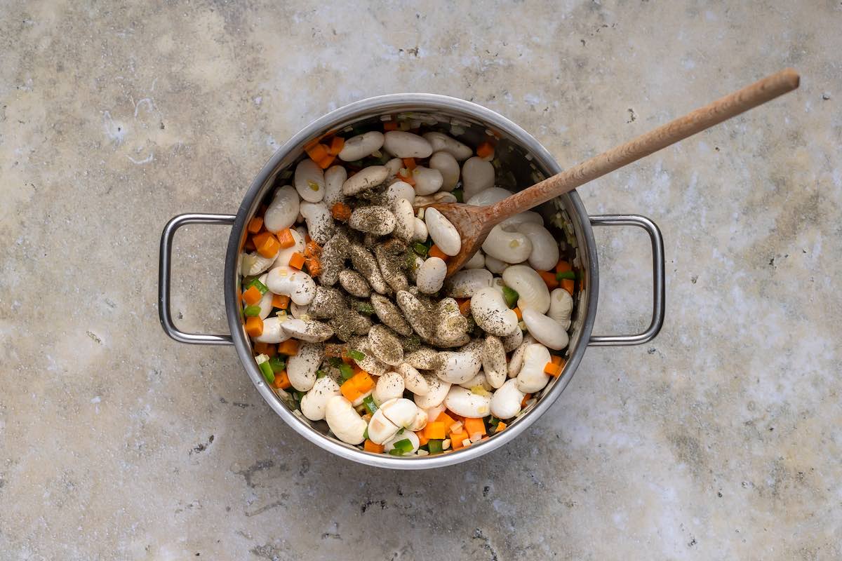 vegetables and butter beans in a pot.