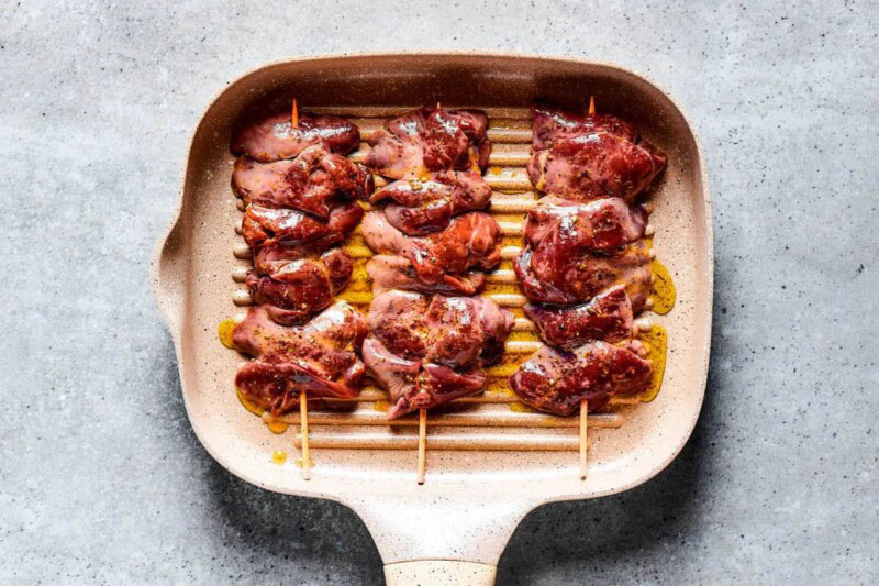 sauteing skewered chicken livers.