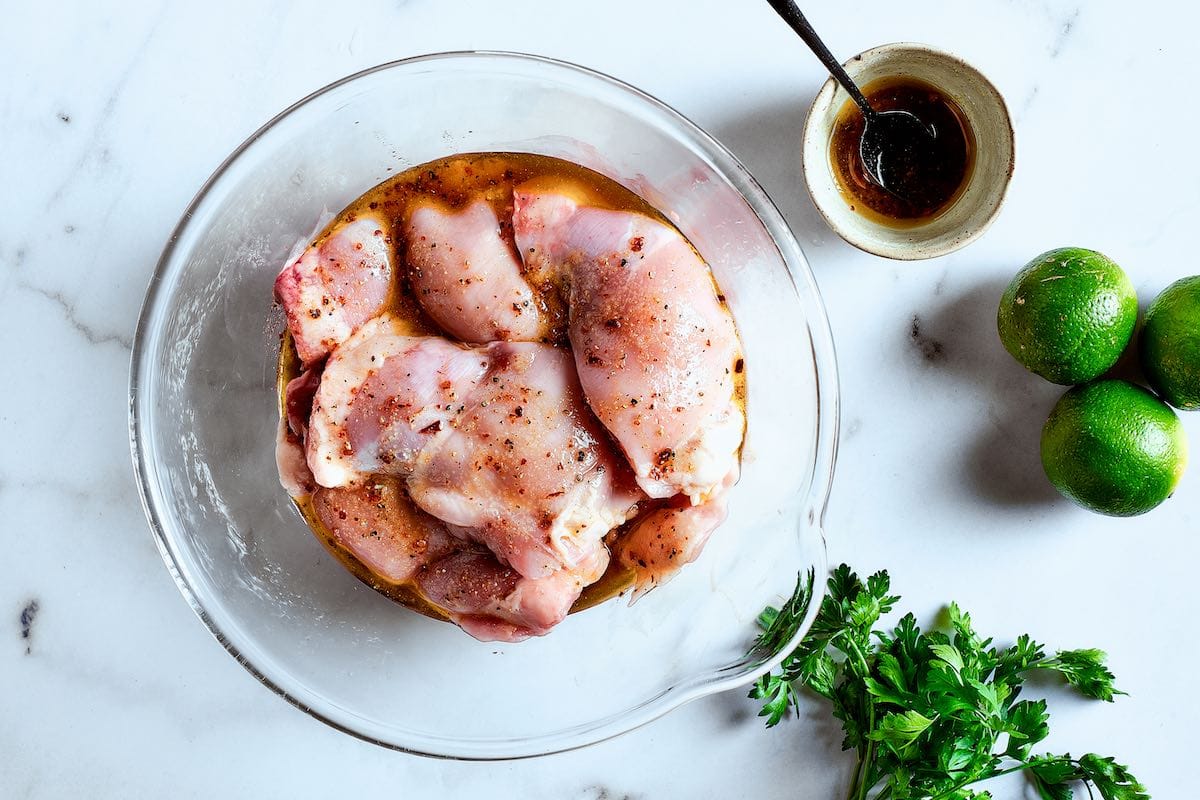 raw chicken thighs soaking in the marinade.