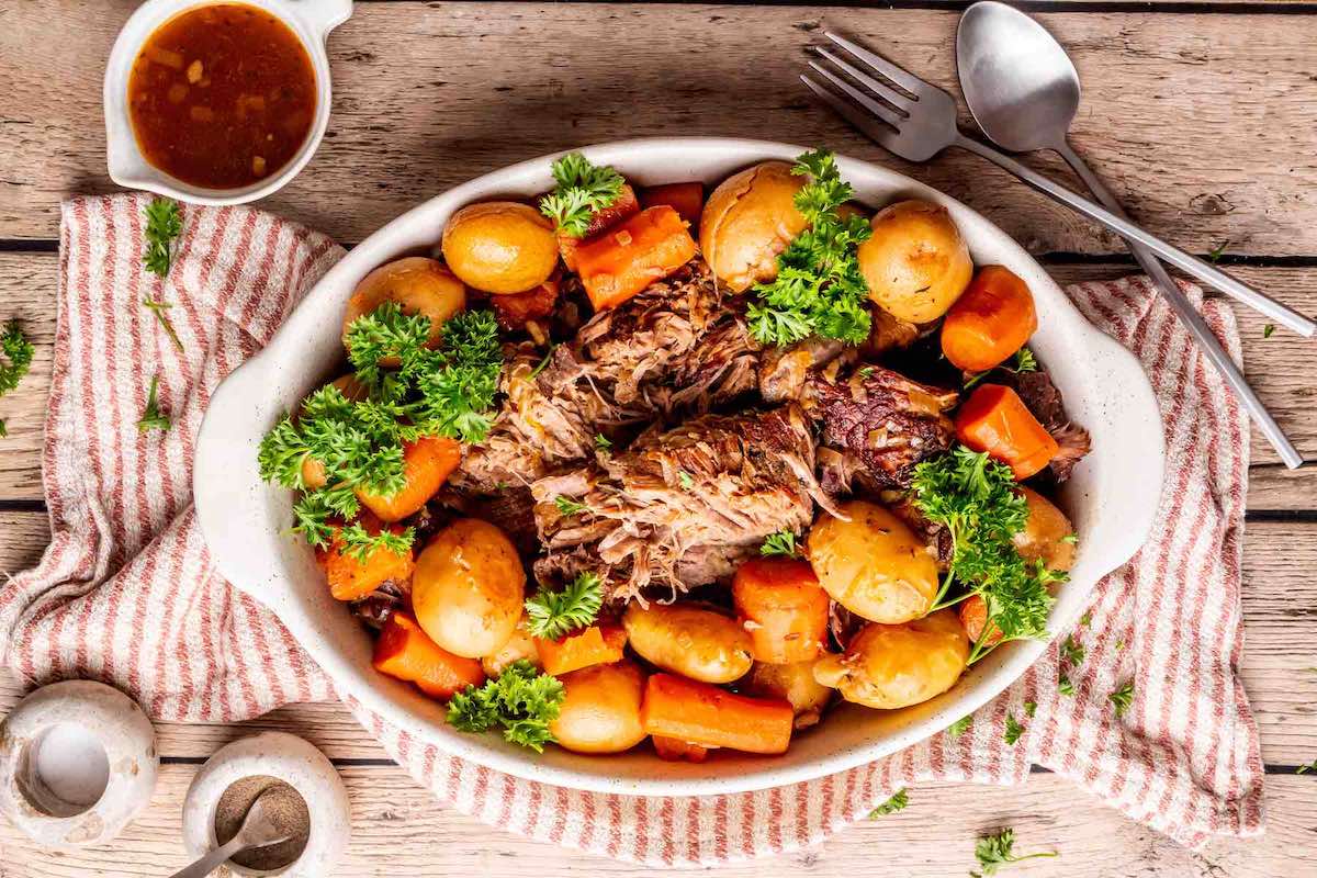 cooked potatoes and carrots with tender roast.