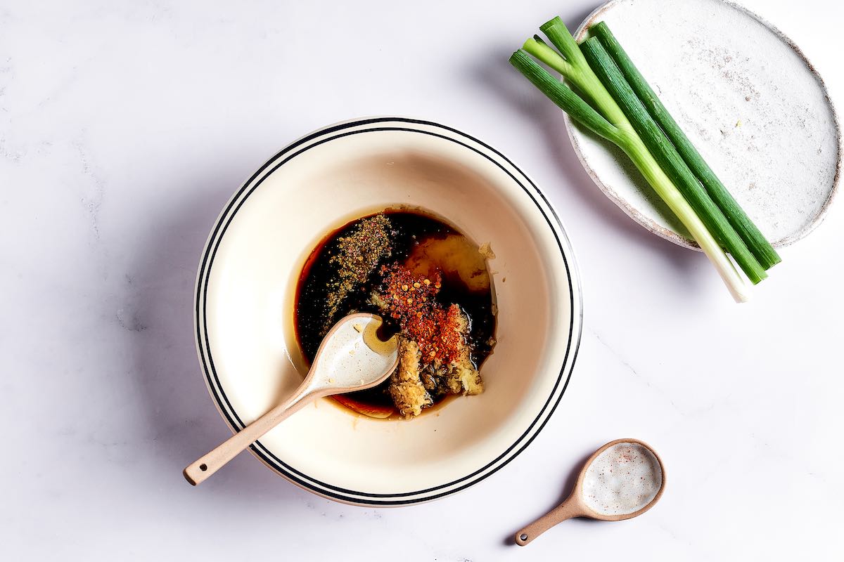 soy sauce, aromatics, and spices in a bowl.