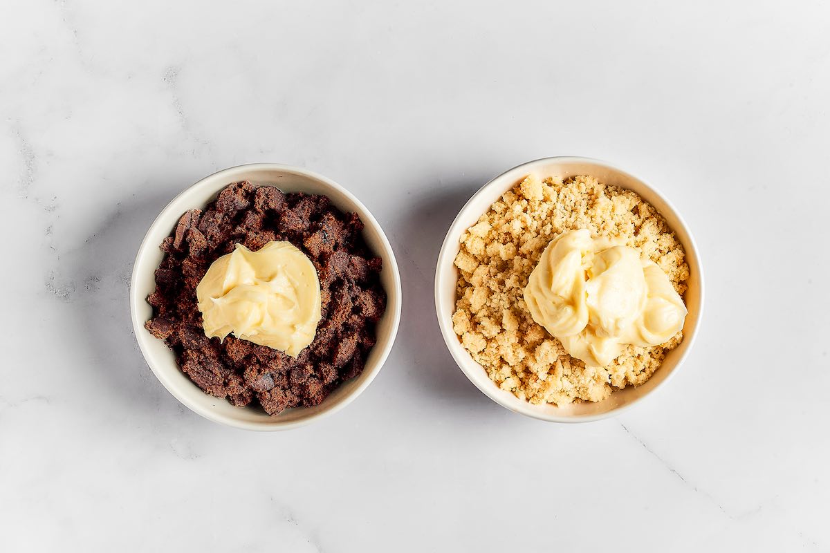 crumbled cake with frosting in bowls.