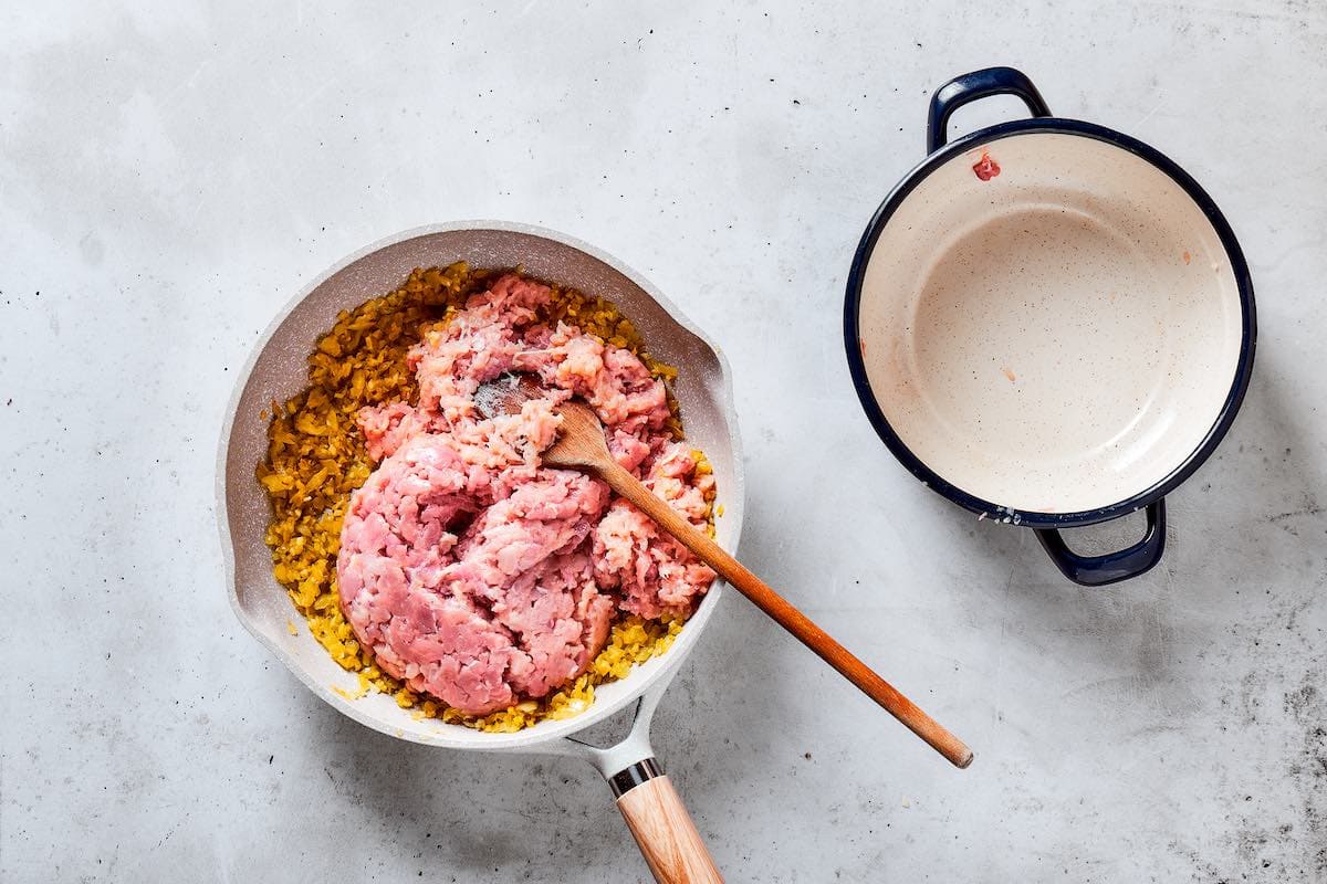 raw ground chicken in a skillet.