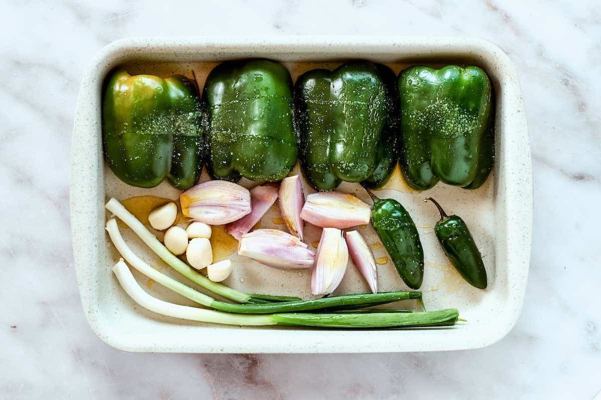 bell peppers, jalapenos, onion, and garlic in a baking sheet.