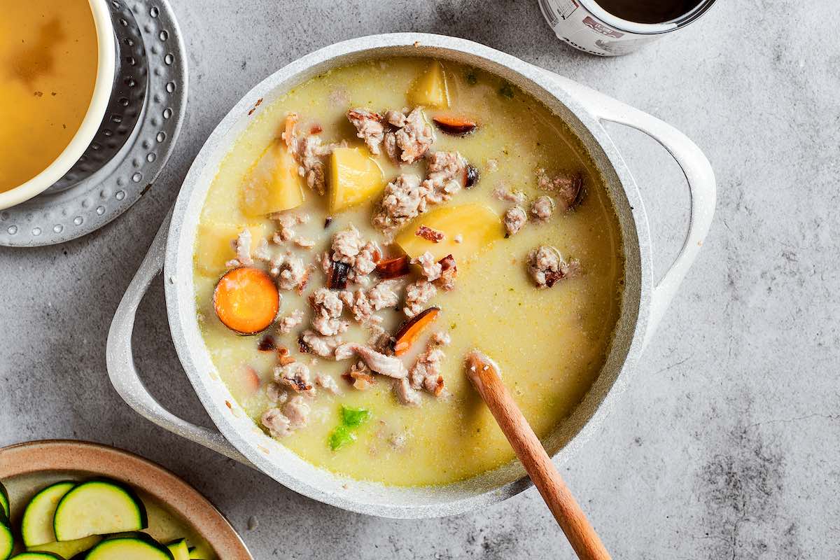 broth and coconut milk added to skillet with potatoes and ground turkey.