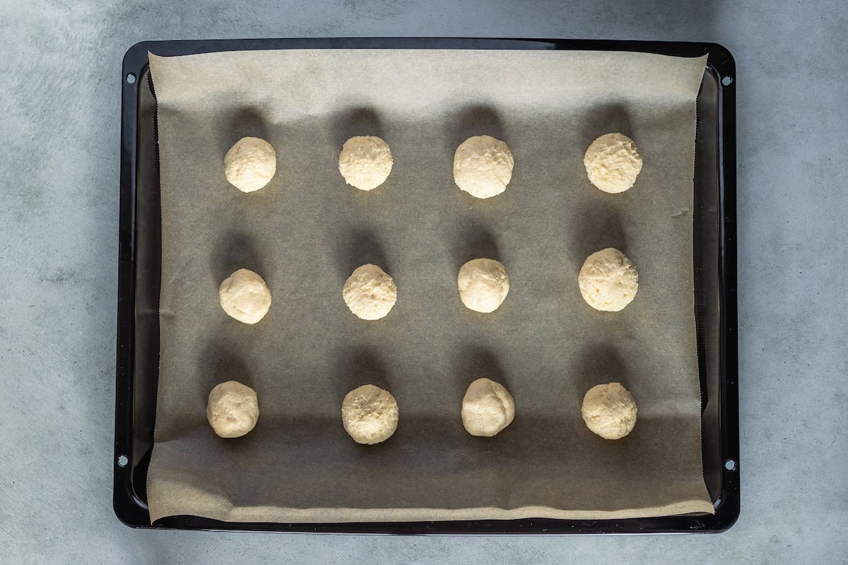 balls of cookie dough on a baking sheet.