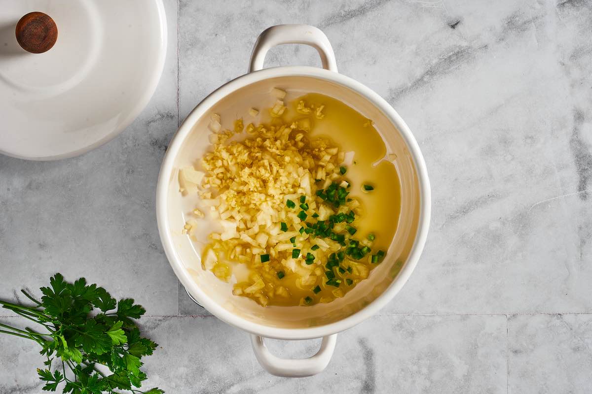 aromatics and chicken broth in a sauce pot.