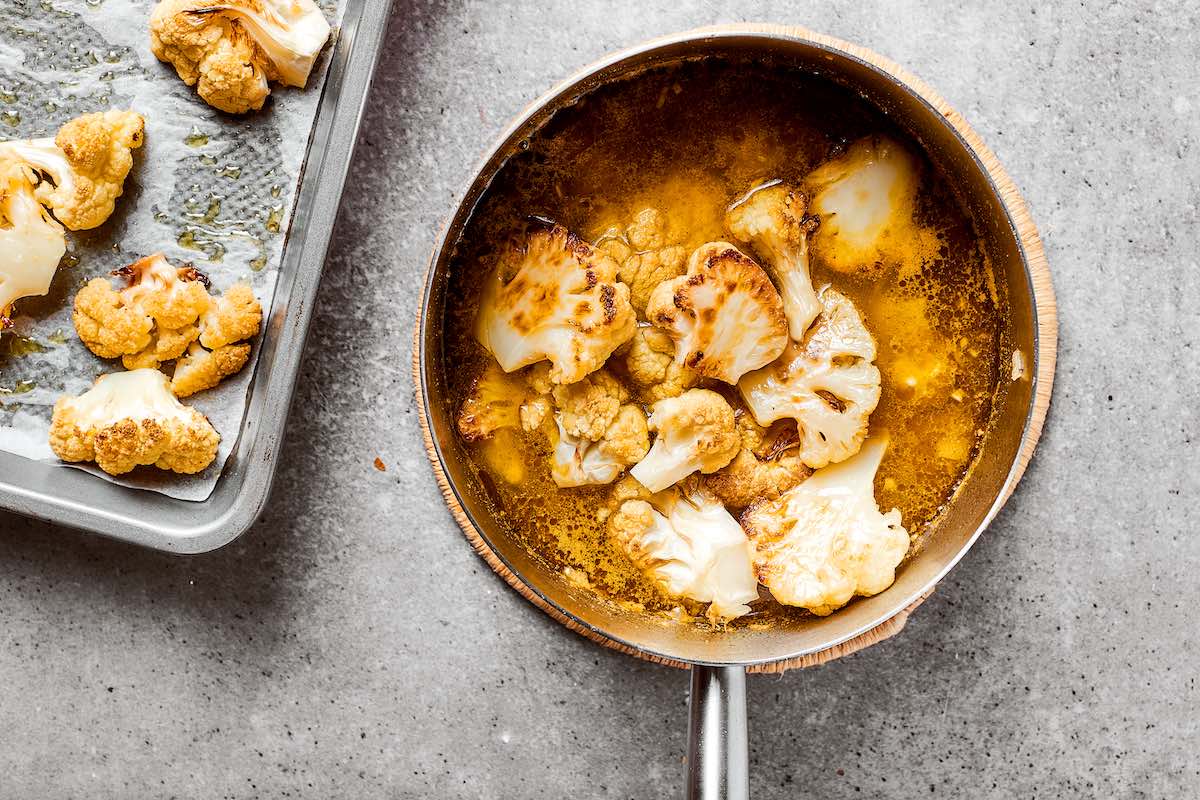 adding roasted cauliflower to broth mixture.