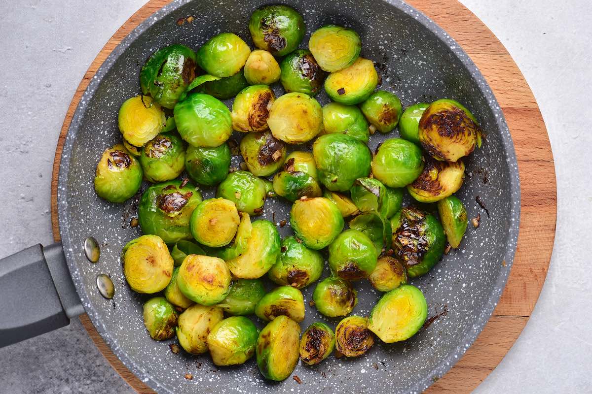 brussels sprouts sauteing in a skillet.