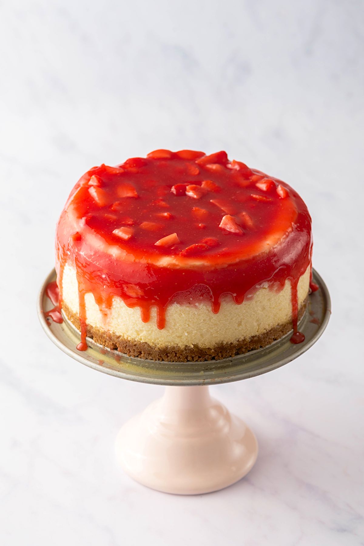 baked strawberry cheesecake on a cake pan.