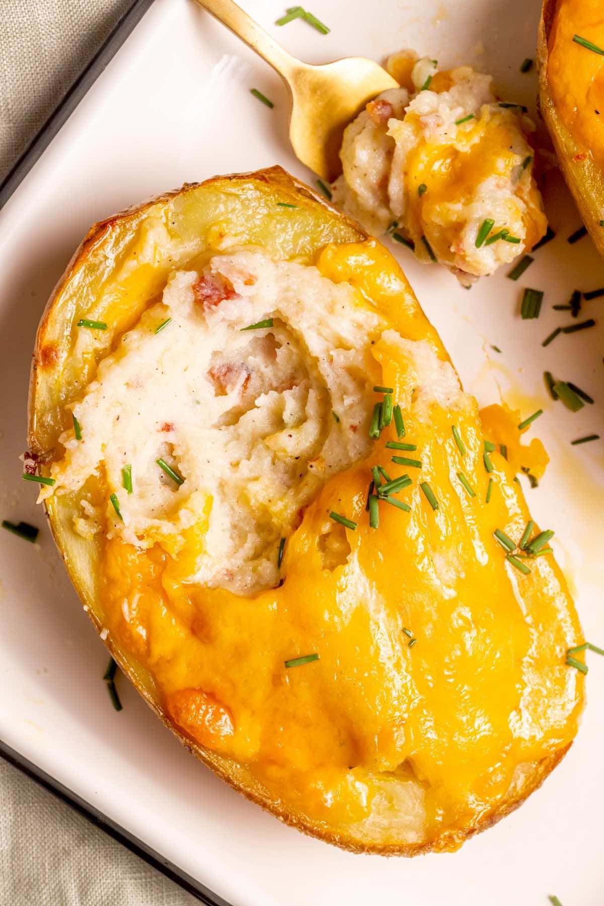 stuffed baked potato with cheese on top.