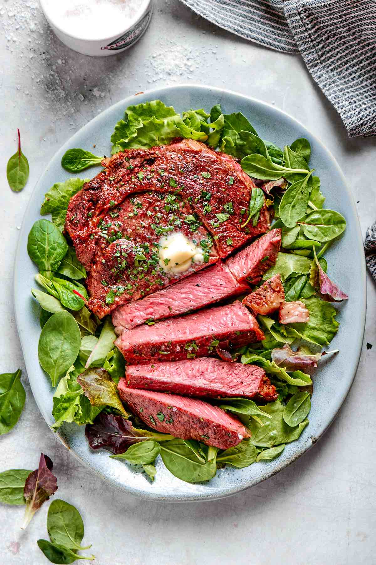 air fryer ribeye steak with butter on top.