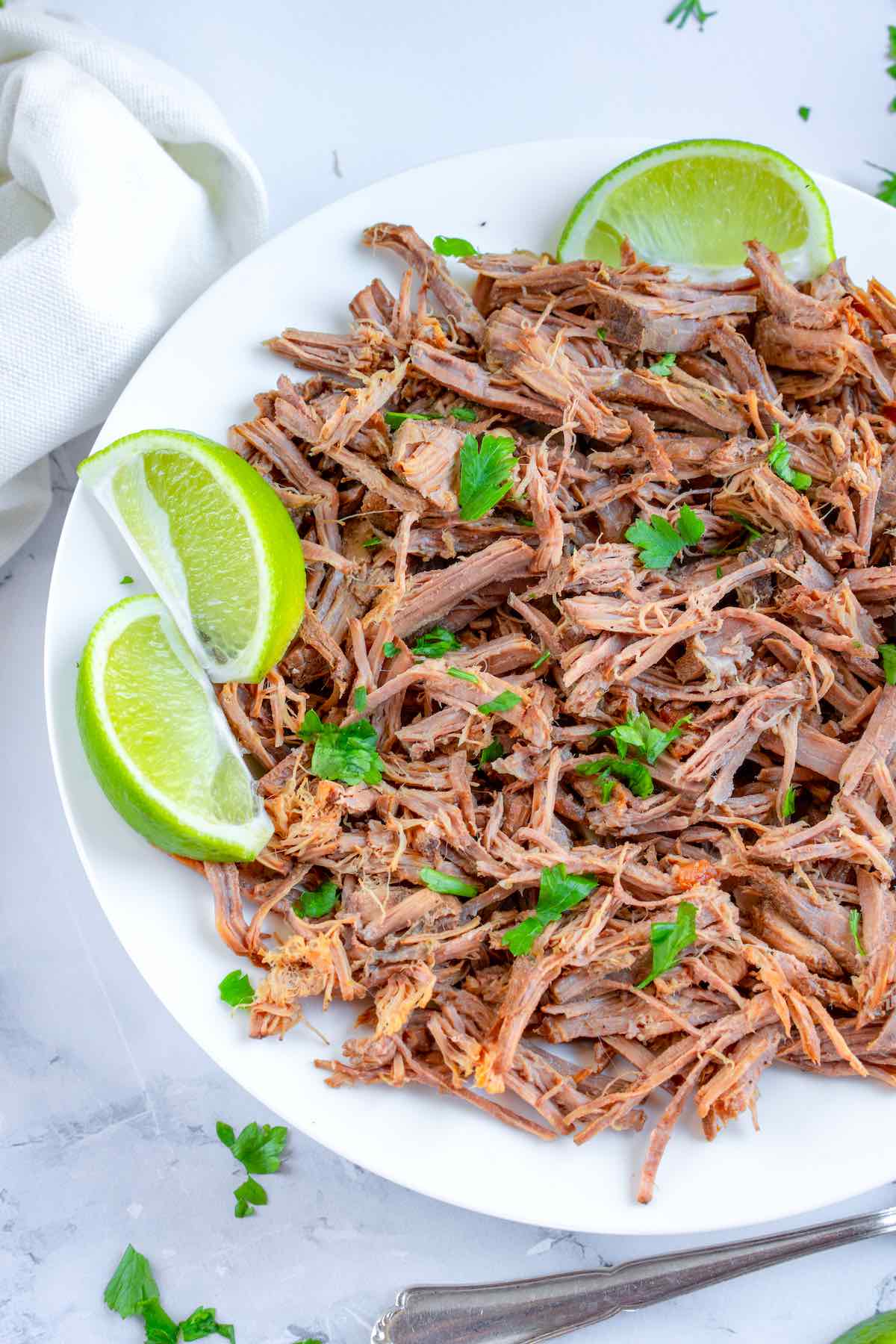 beef barbacoa with fresh, sliced limes.