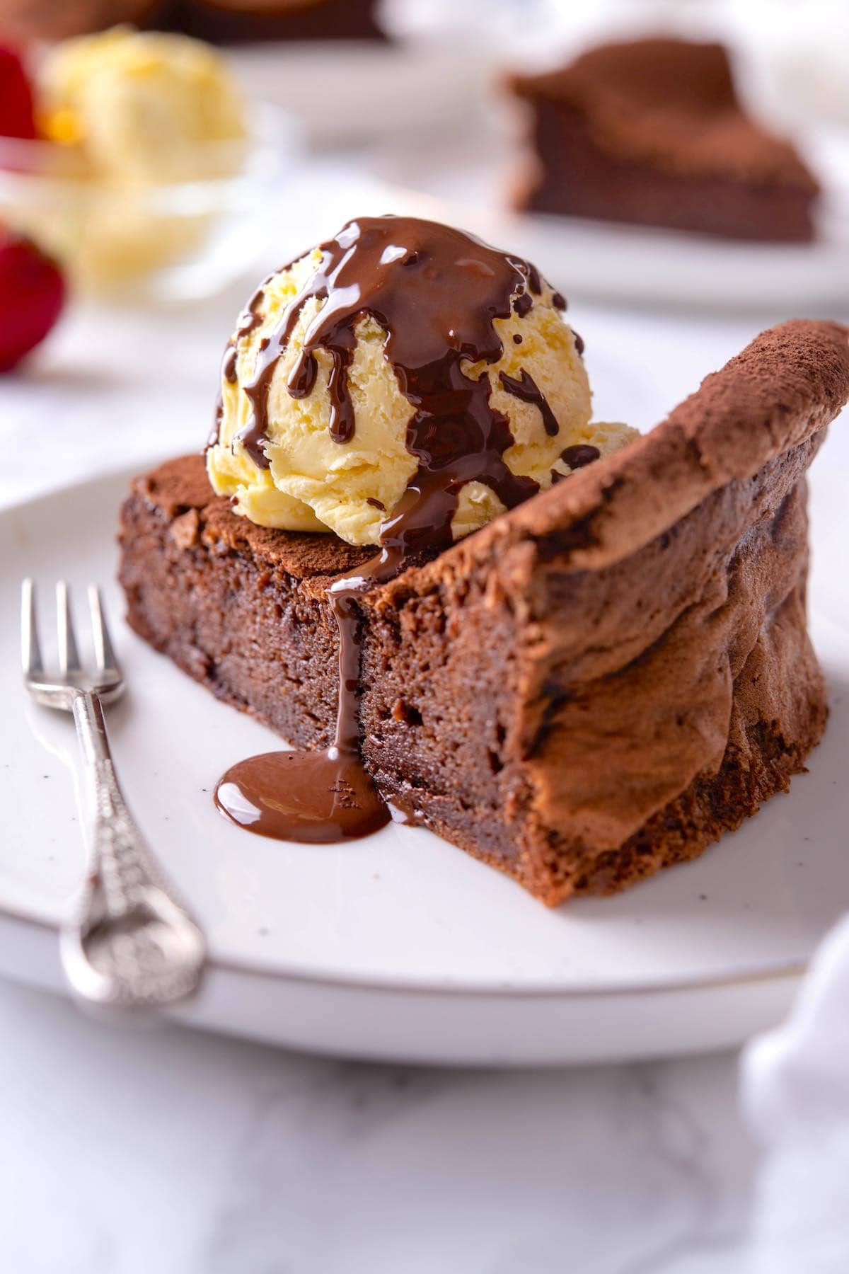 flourless chocolate cake with ice cream on top.