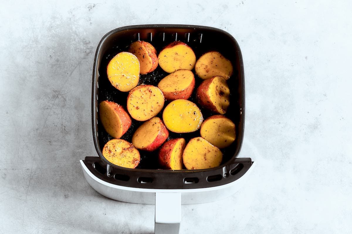 raw red potatoes in the air fryer basket.