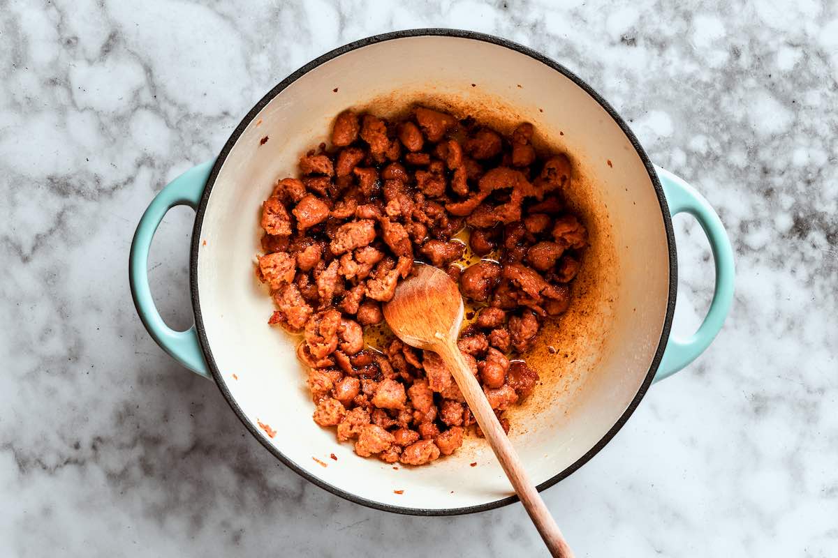 sausage crumbles cooking in soup pot.