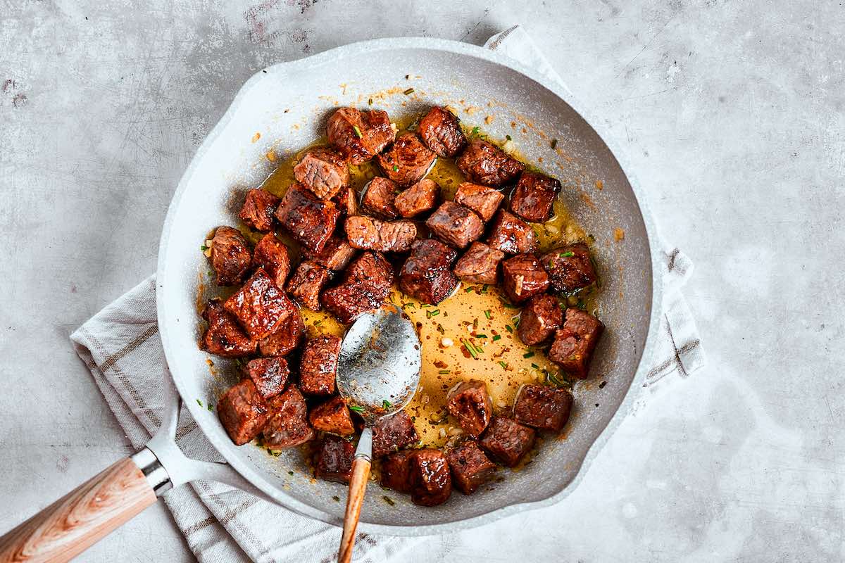 melted garlic butter tossed through steak bites.