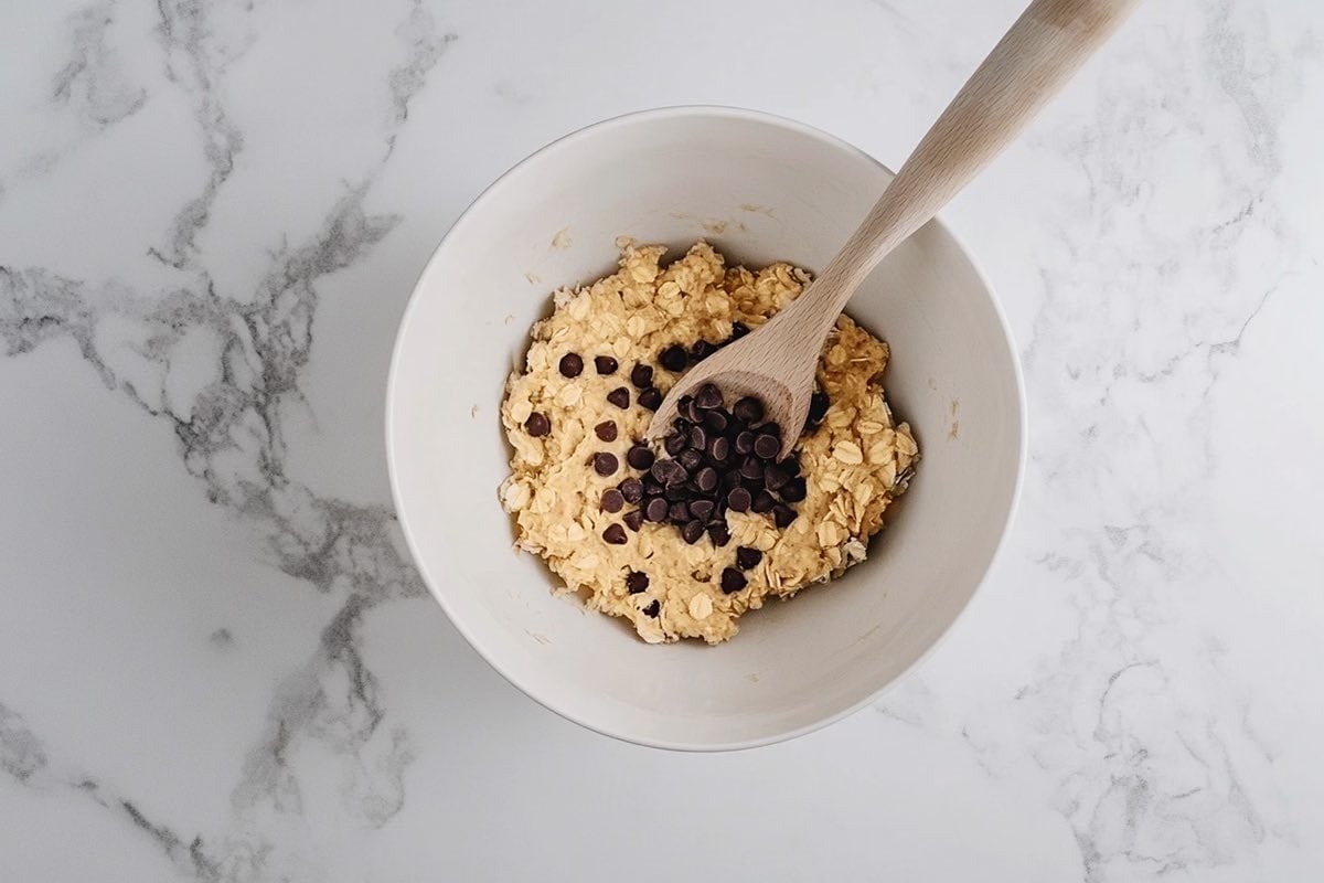 oats, banana, and chocolate chips in a mixing bowl.