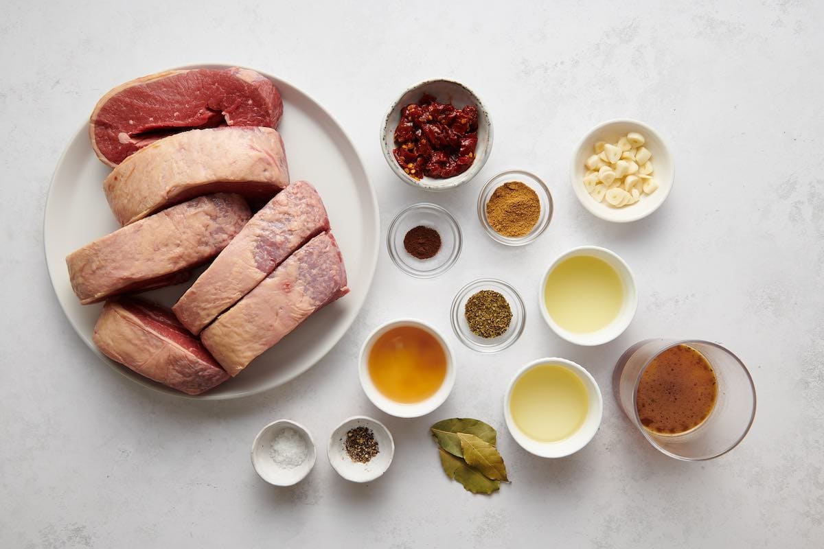 raw beef chuck with seasonings in bowls.