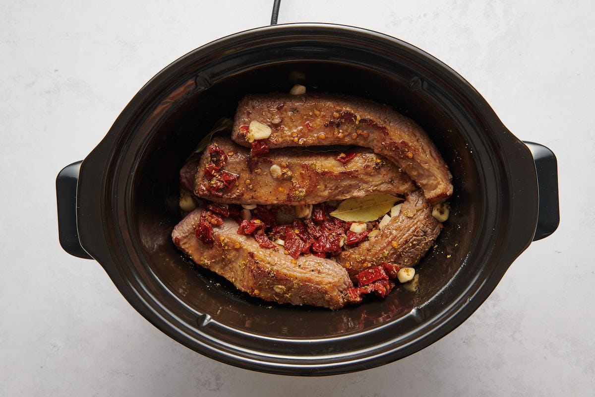 beef and seasonings in slow cooker.