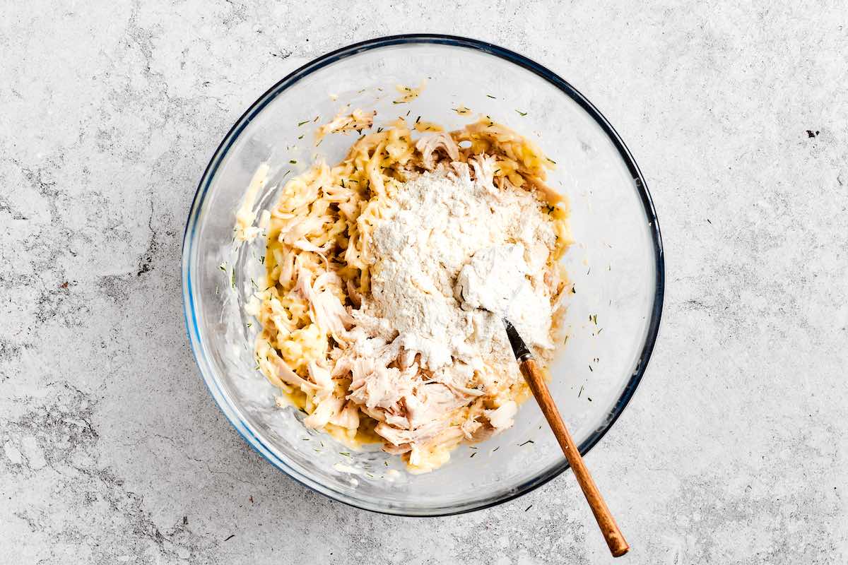 ground chicken, parmesan, and flour in a bowl.