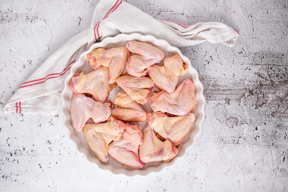 raw chicken wings in a baking dish.