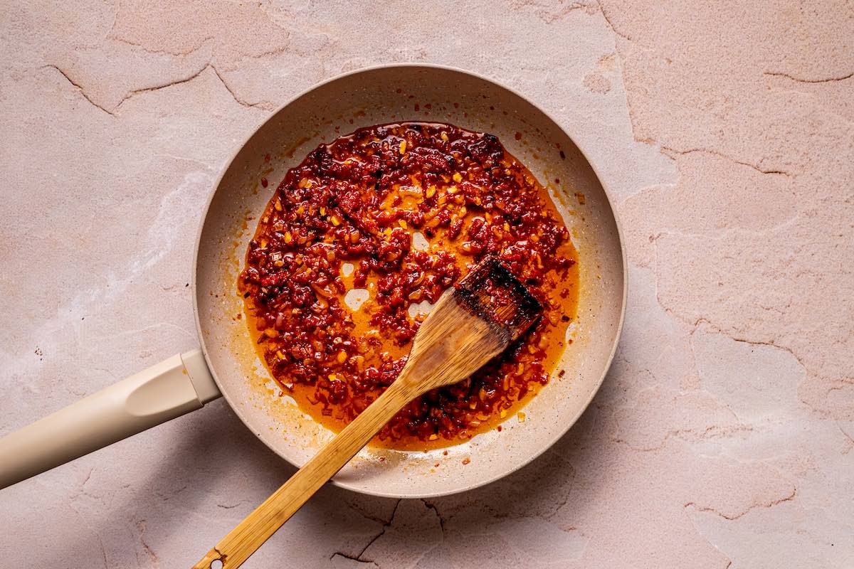 aromatics and tomato in a skillet.