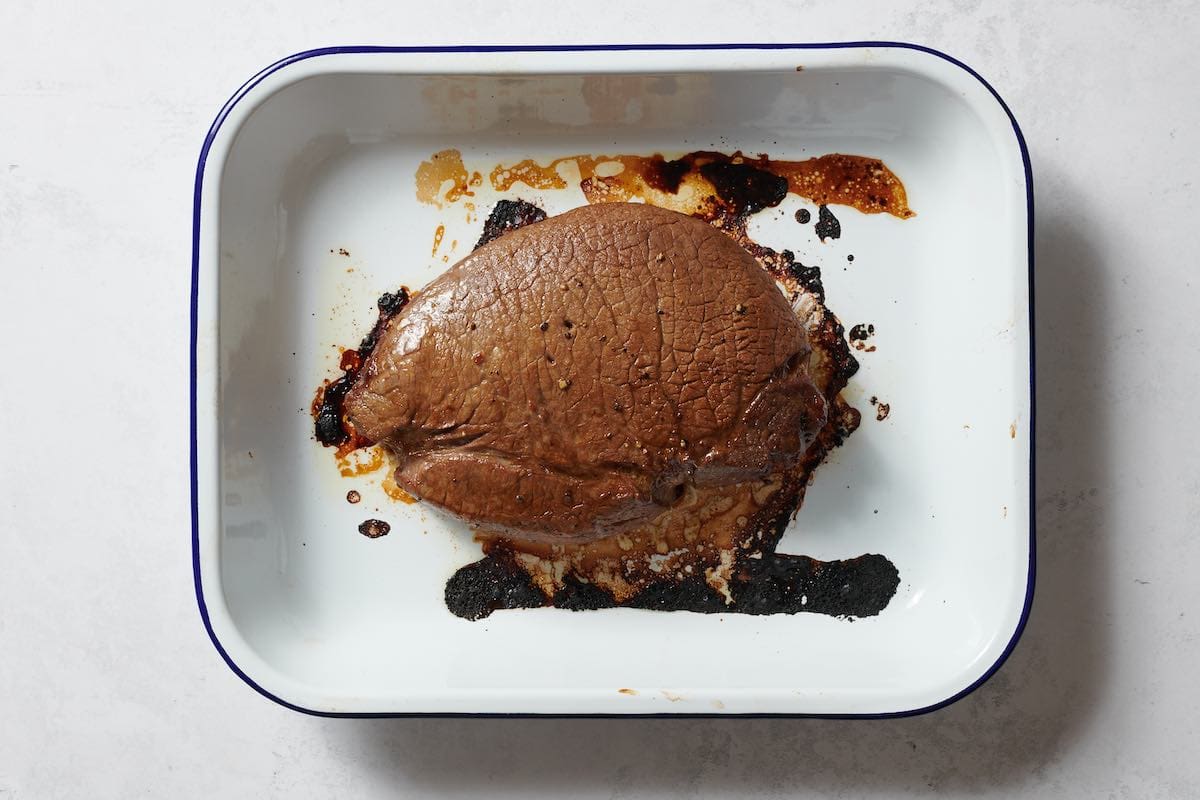 roasted shoulder roast in baking dish.