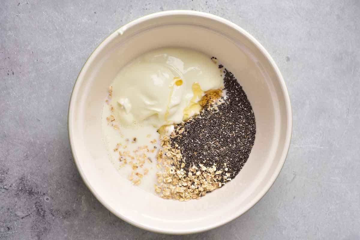 steel cut oats, chia seeds, yogurt, and milk in bowl.