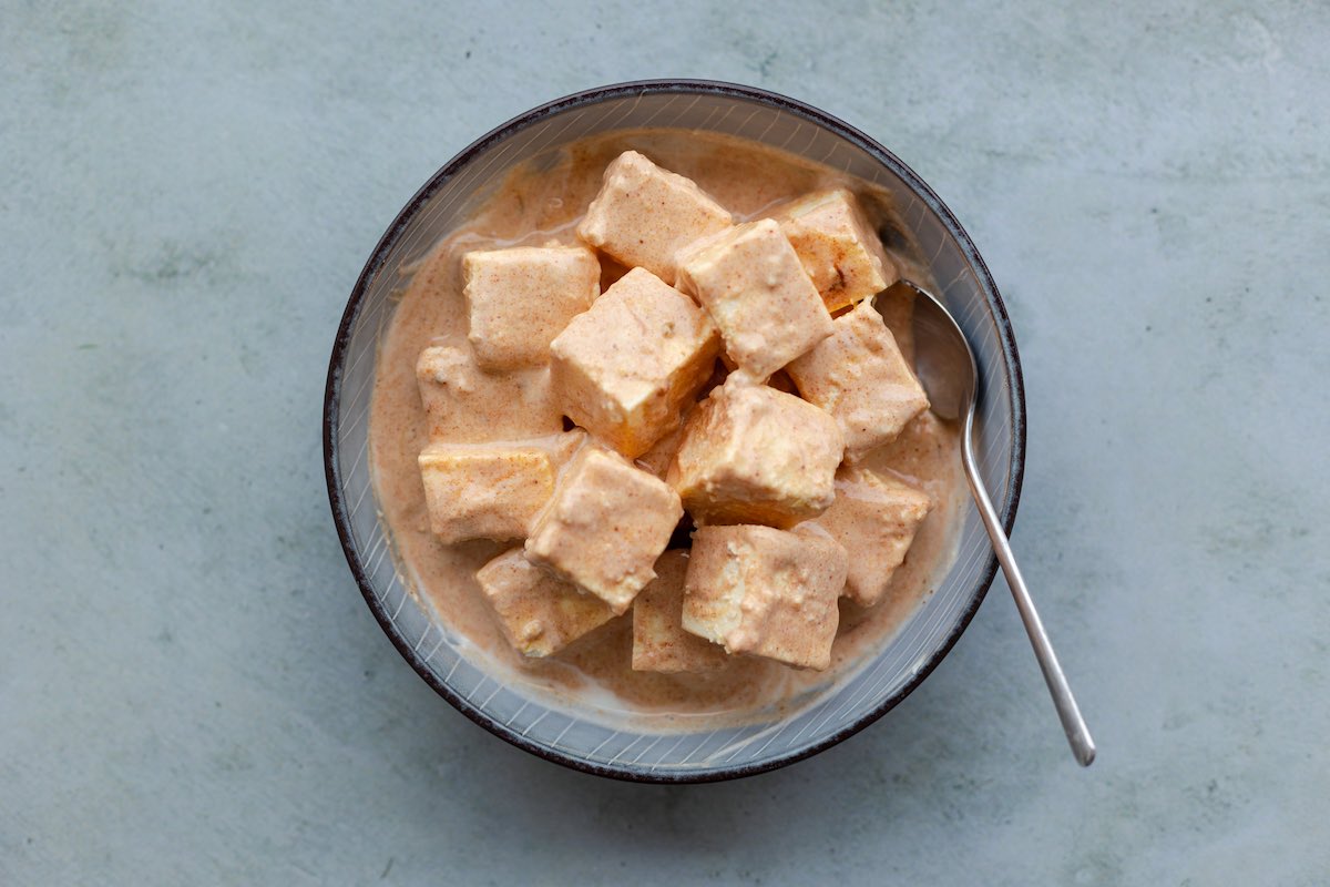 paneer marinating in a bowl.